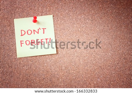 dont forget or do  not forget reminder, written on Yellow Sticker on Cork Bulletin or Message Board.
