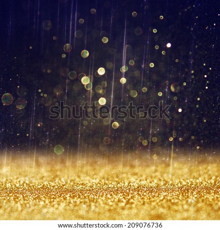 glitter vintage lights background. light gold and black. defocused.