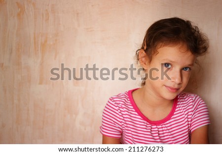 portrait of cute kid\'s headshot, against textured background.