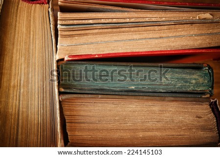 Top view of old books on a wooden table. retro filtered image