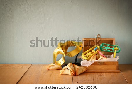 Hamantaschen cookies or hamans ears and mask for Purim celebration (jewish holiday). filtered image