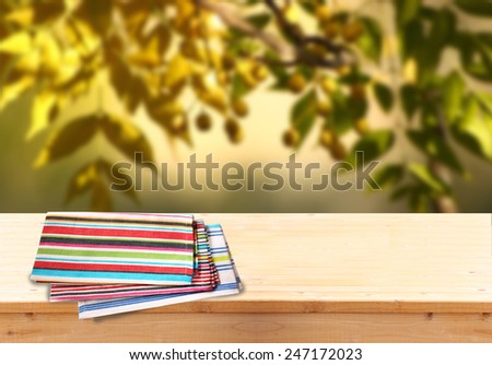 image of front rustic wood boards with towel against background of olive tree. image is retro toned and Ready for product display montages