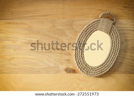 top view of vintage frame from ropes on wooden table