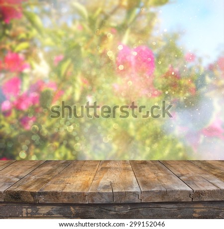 wood board table in front of summer landscape of flower bloom