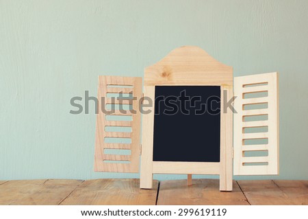 image of vintage wooden classical frame on wooden table. filtered image
