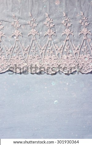 top view of vintage hand made beautiful lace fabric. with glitter overlay