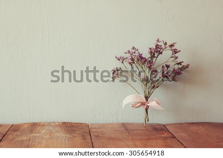 bouquet of dried flowers rope against wooden background
