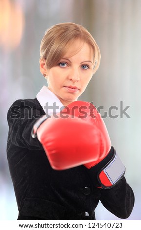 Portrait of  young female entrepreneur wearing boxing gloves
