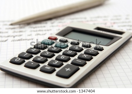 A calculator and pen indicate use by a professional for business purposes.