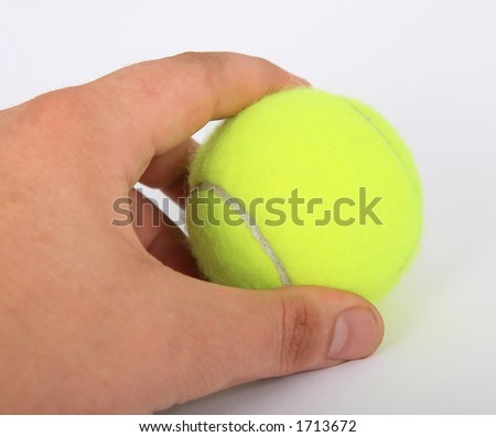 Tennis ball and a hand isolated on white, close-up, copy space, macro,