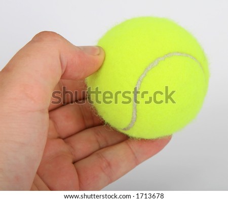 Tennis ball and a hand isolated on white, close-up, copy space, macro,