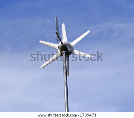 Solar powered environment friendly wind turbine over a blue sky background.
