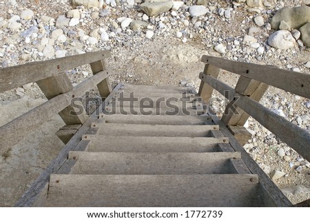 Outdoor wooden staircase with steps leading down to the beach