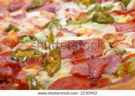 Hot summer jalapeno pepper and meat pizza, macro close up