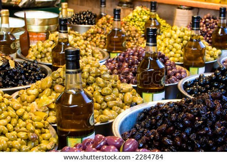 Olives and olive oil for sale at a market for farm products.
