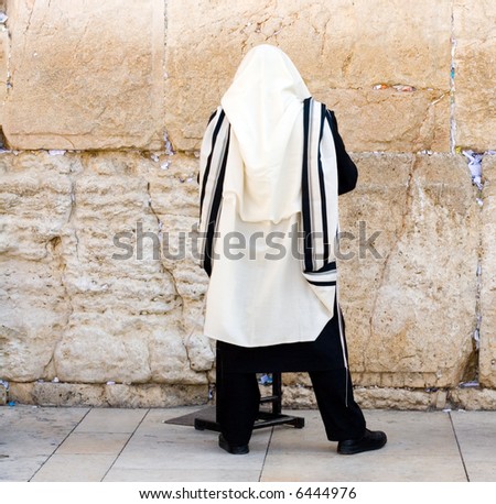 A Religious Orthodox Jew Wearing A Prayer Shawl Draped Prays At The ...