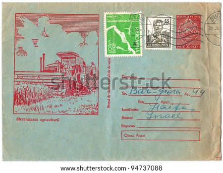 ROMANIA - CIRCA 1958:  An old used Romanian envelope (campaign poster) and stamps issued in honor of the program of agricultural mechanization showing the harvester in the field; series, circa 1958