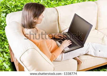 CLIPPING PATH! Woman with laptop on the sofa