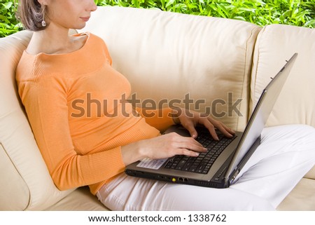 CLIPPING PATH! Woman with laptop on the sofa