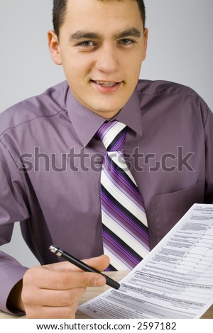 Smiling businessman at the desk giving you contract to sign. (Contract\'s form is copyright free)