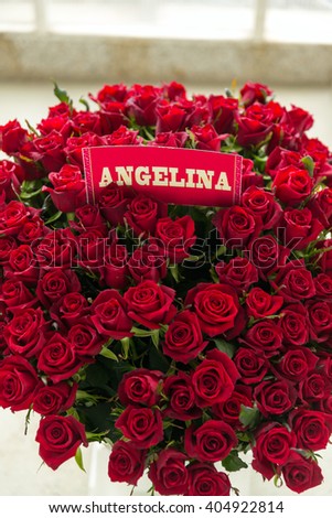 stock-photo-angelina-red-rose-bouquet-with-name-label-404922814.jpg