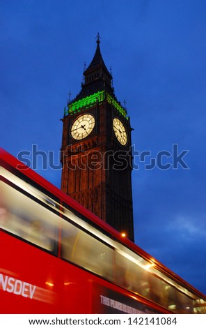 LONDON - 5 NOV: London bus in motion at night, Big Ben at Behind, on 5 Nov 2009 in London, UK