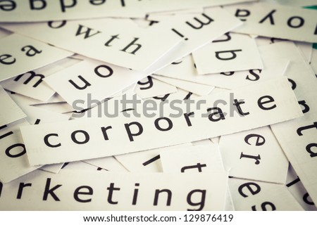 Corporate topic, cut paper on the top of others word