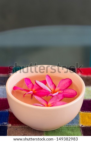 Decorative flower bowl on colorful table cloth