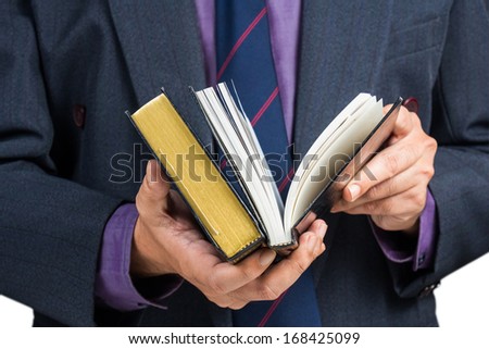 Businessman searching information in reference book