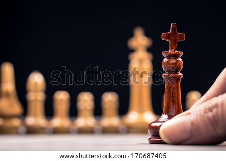 Closeup queen chess and row of competitor for business concept