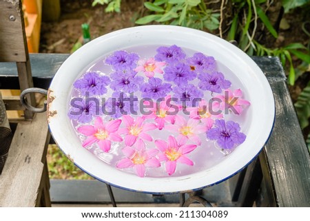 Floating flowers in metallic basin, decorated in the garden