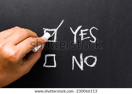Hand writing correct mark in the box of Yes or No choice
