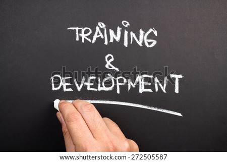 Hand writing Training and Development topic on chalkboard