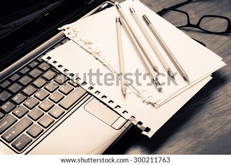 Pencils and papers on laptop, communication writing concept