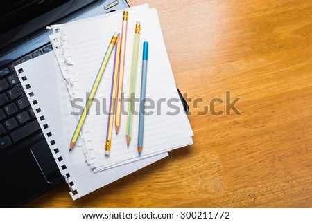 Pencils and papers on laptop, communication writing concept