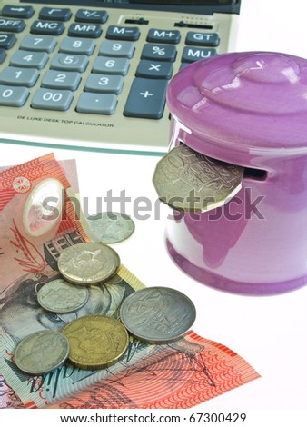 Australian money with pink piggy bank and calculator