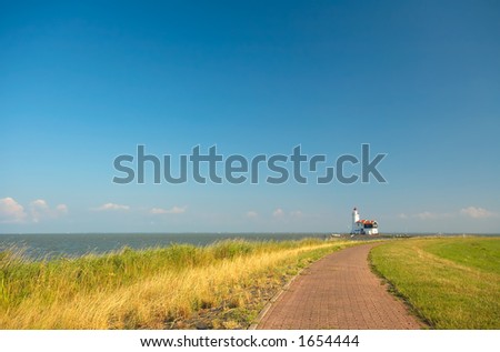 road to a lighthouse on s a summer day