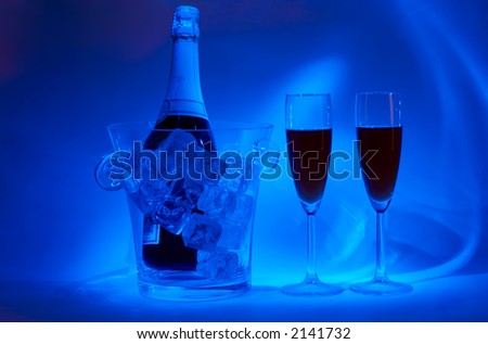 Night-time cellebration (bottle in jar with icecubes and two drinks in special light)