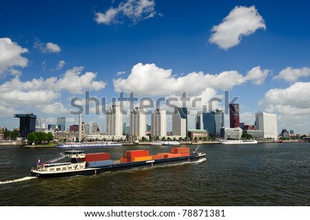 Rotterdam skyline and a container ship on the meuse river the Netherlands, Europe