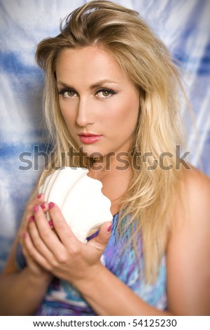 blond women hold white shell