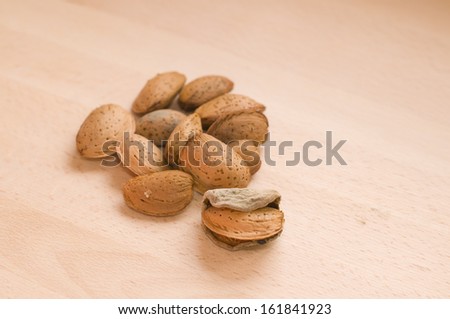 Group of almonds and one of them with its natural skin