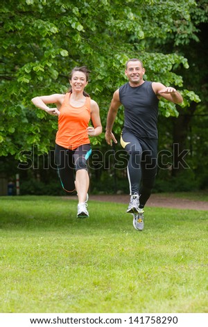 Man and woman running in forest