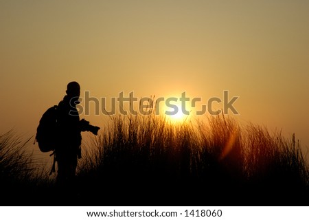 Man is taking a picture from the sunset on the island sylt, germany
