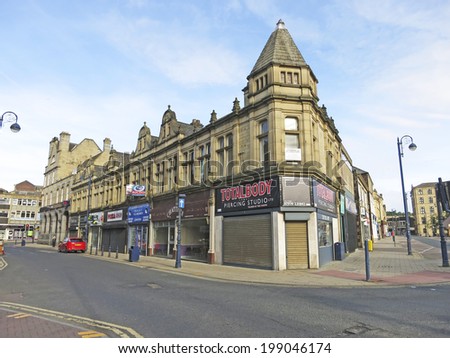DEWSBURY, UK -JUNE 16: Shops, Dewsbury, West Yorkshire, England, UK, 16 June 2014. Dewsbury,  after a period of decline, is redeveloping  derelict mills into flats and regenerating city areas.
