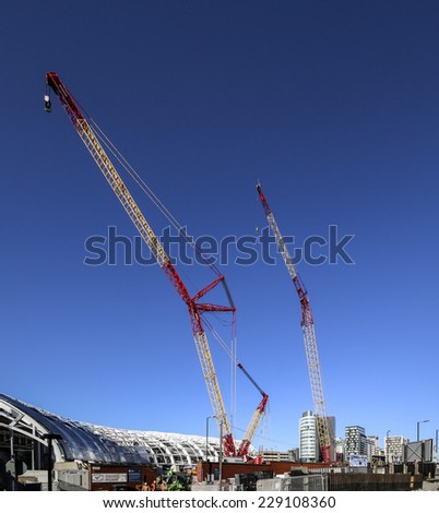 MANCHESTER, UK - NOVEMBER 5, 2014: Cranes above Victoria Station, Manchester which are helping the construction of the tram terminal for the second cross-city tramway.
