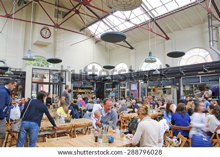 ALTRINCHAM, UK - JUNE 7 2015: The food hall at Altrincham market, Manchester. Altrincham is a market town in Trafford, Greater Manchester and an affluent commuter town
