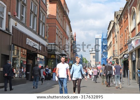 NOTTINGHAM, UK - SEPTEMBER 11, 2015: Shoppers in Nottingham City Centre and the centre of the city is usually defined as the Old Market Square - the UK\'s largest city square