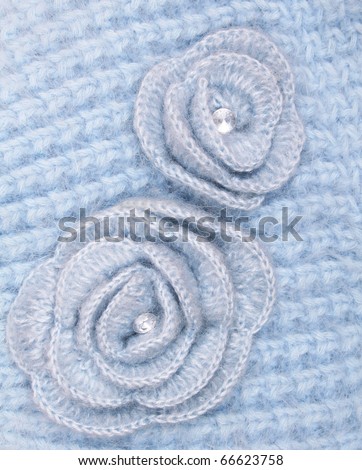 Blue wool flowers on blue wool knitted background