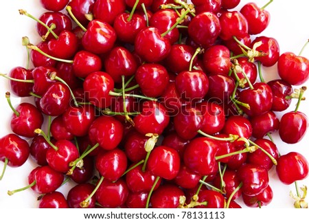 Wet ripe red cherries on white plate background