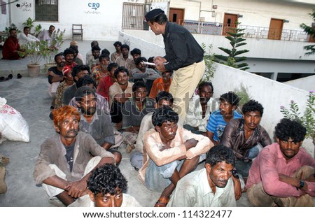 KARACHI, PAKISTAN - OCT 01: Arrested Indian fishermen sit at docks police station after their arrest, on October 01, 2012 in Karachi.